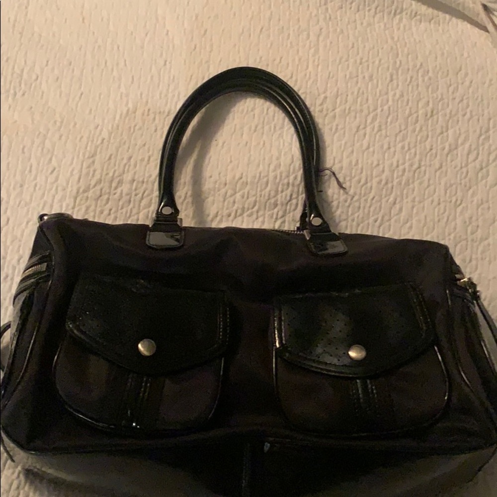 Cole Haan mini duffel bag with patent trim